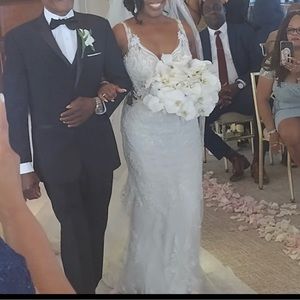 This is a beautiful lace wedding gown with gorgeous details in the back.